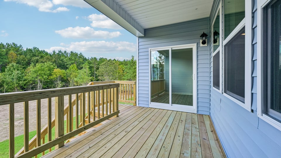 covered back deck with sliding glass doors