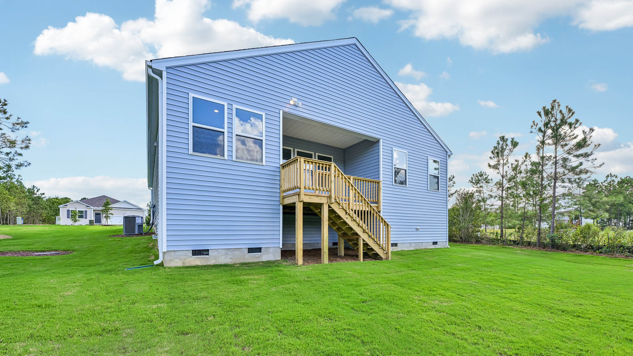 back of home with covered back deck
