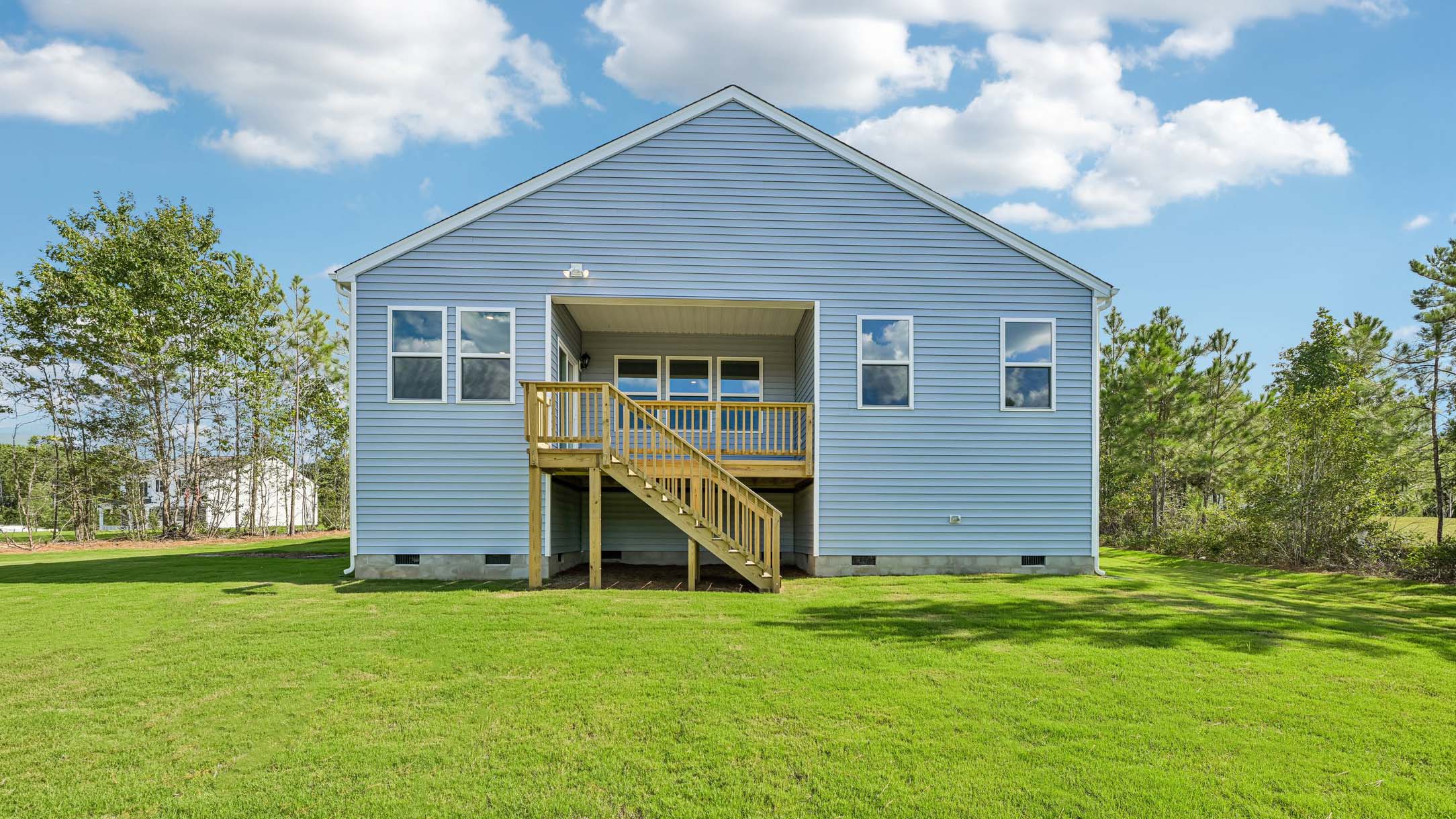 back of home with covered back deck