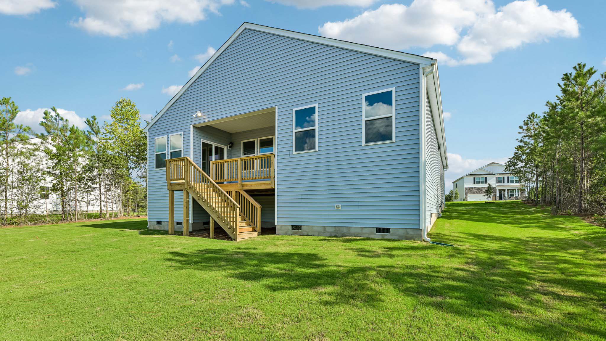 back of home with covered back deck