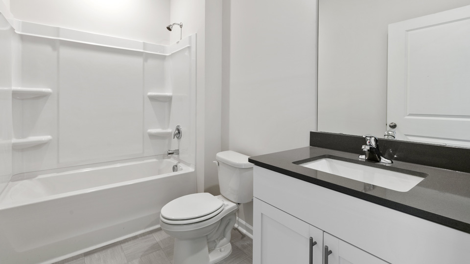 secondary bathroom with shower tub combo and single vanity sink