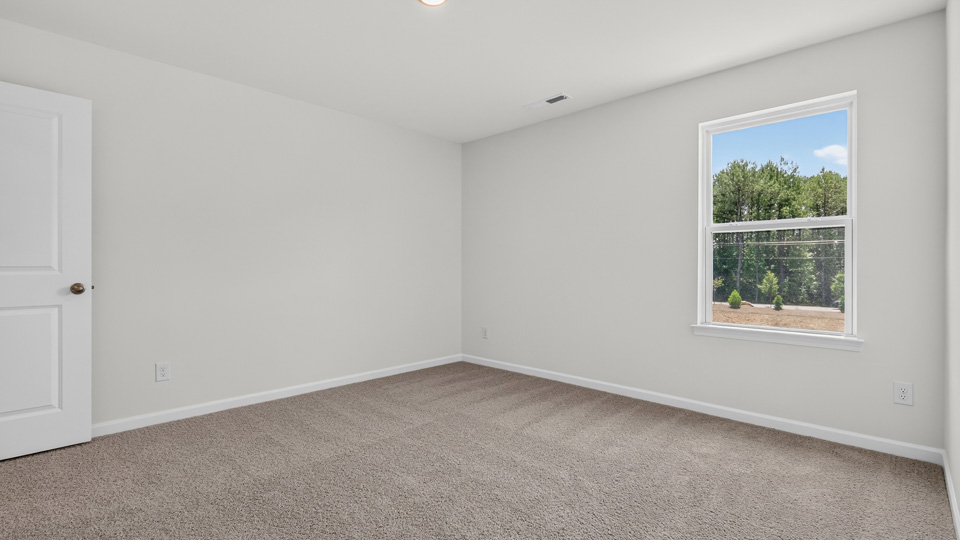 additional bedroom with window, carpeting, closet