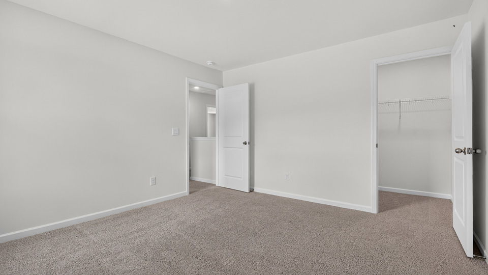 additional bedroom with window, carpeting, closet