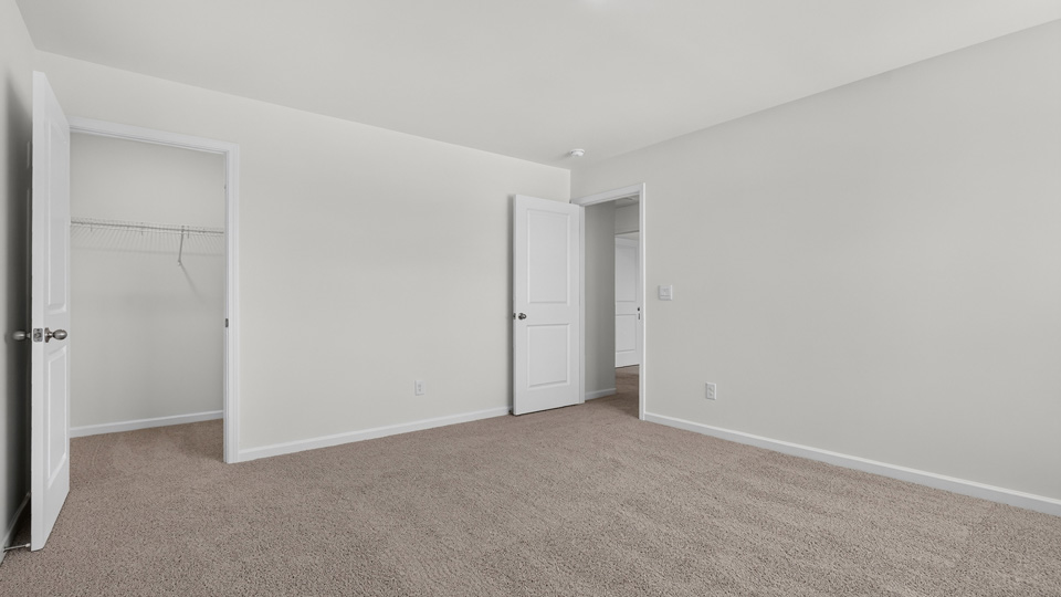 additional bedroom with window, carpeting, closet