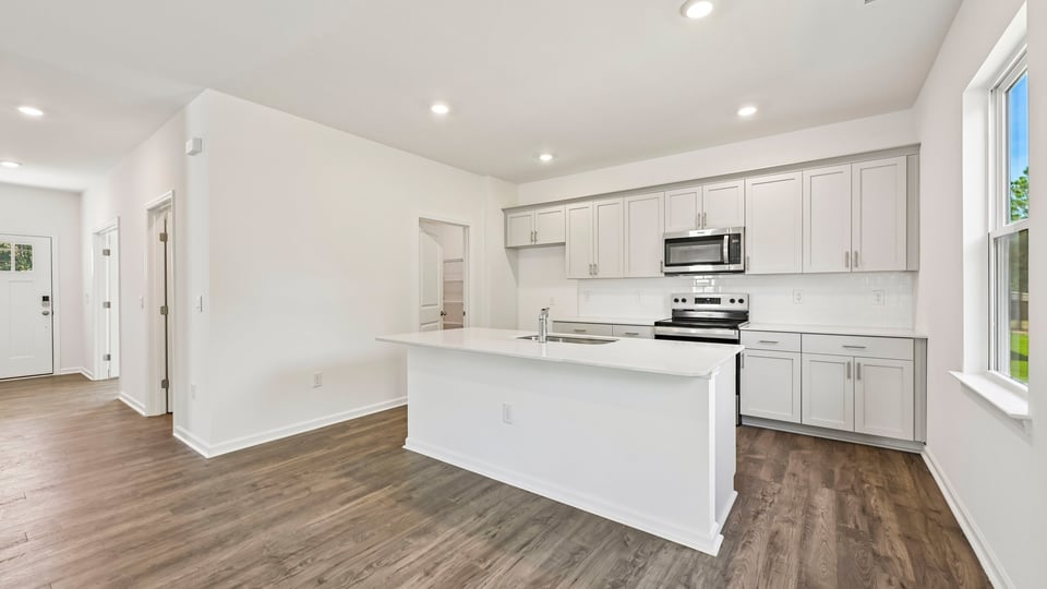 kitchen with center island white cabinets and quartz countertops