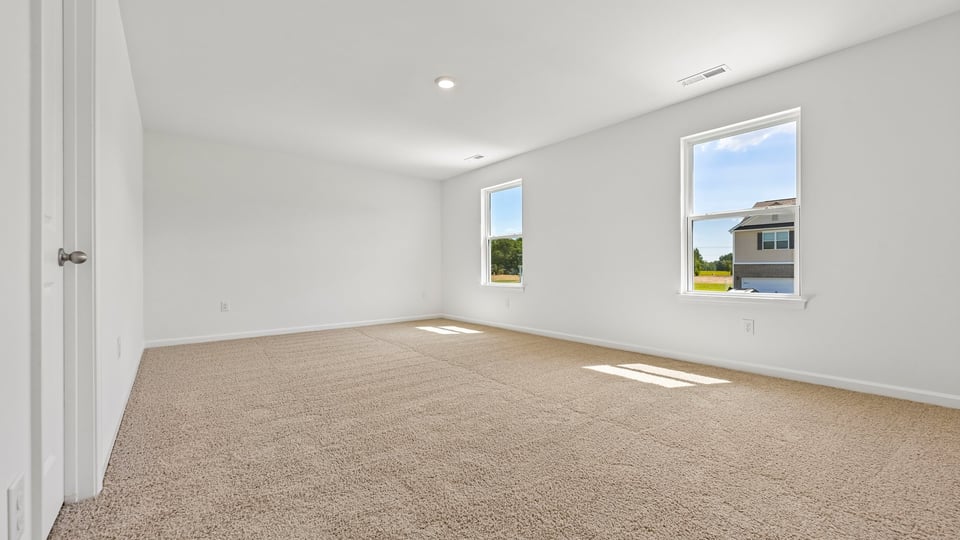 primary bedroom with carpet flooring