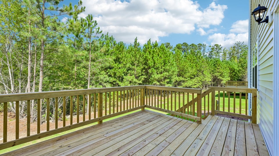 uncovered back deck with treelined back yard