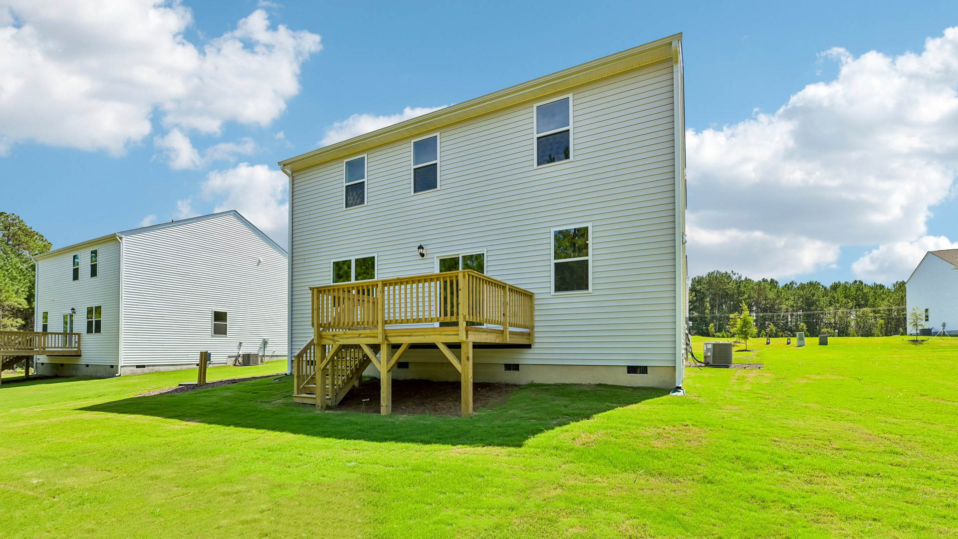 back of home with uncovered back deck