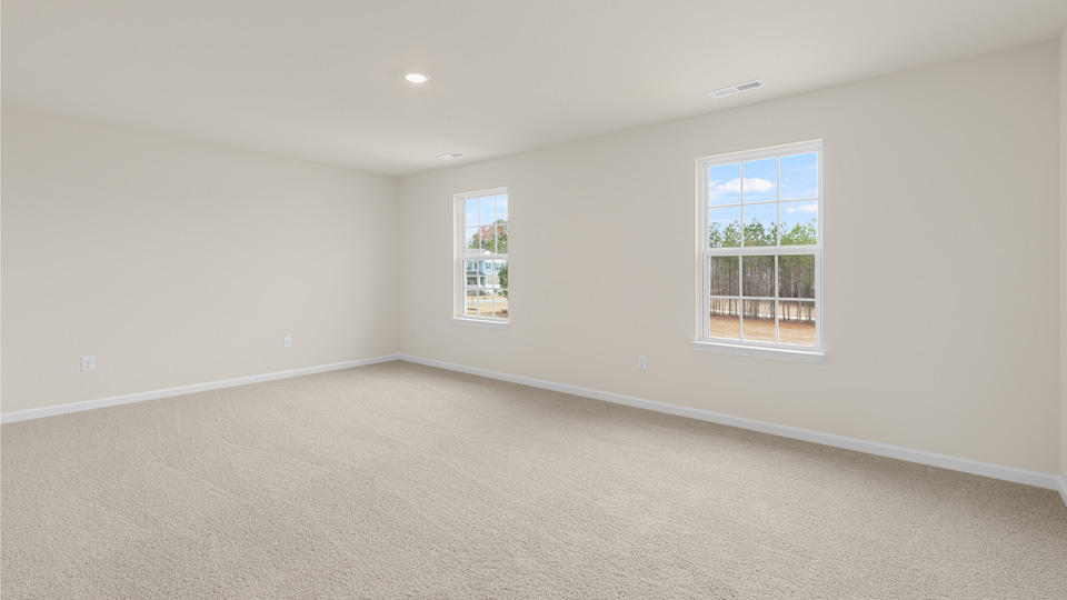 Primary bedroom with carpet flooring