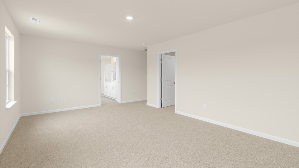Primary bedroom with carpet flooring