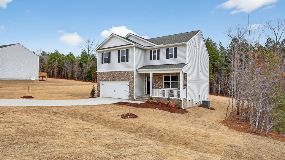 Two story home with white colored siding with a two car garage