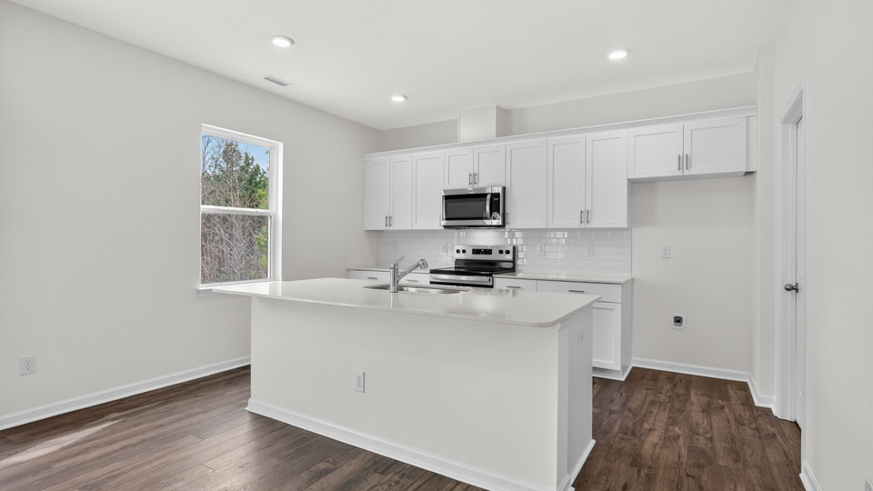 Kitchen with white cabinets and stainless steel appliances.