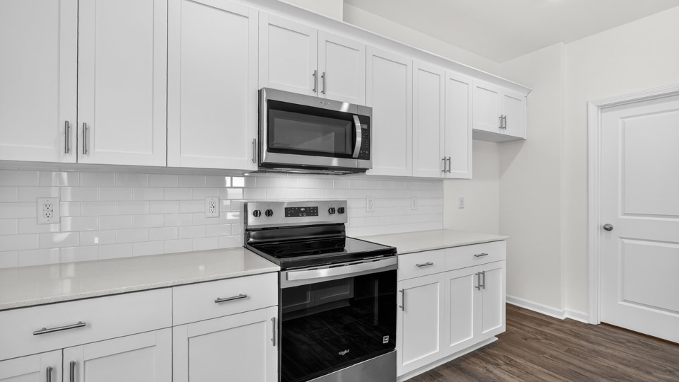 Kitchen with white cabinets and stainless steel appliances.