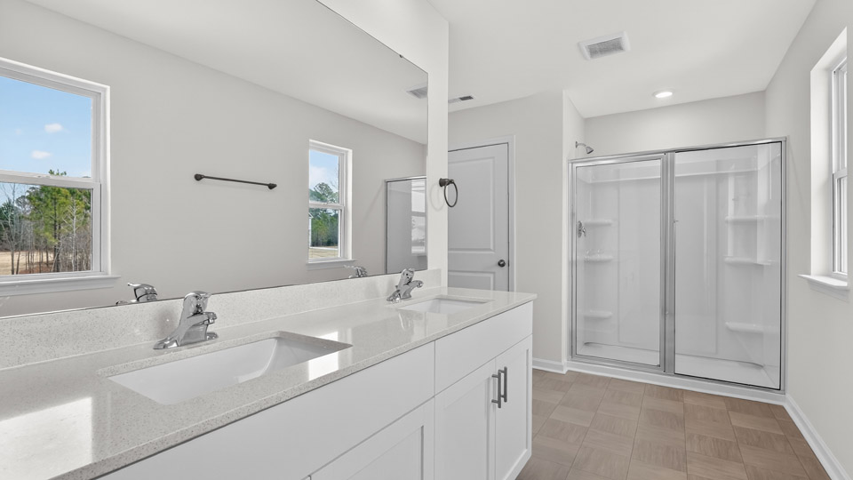 Primary bathroom with double sink and walk-in shower
