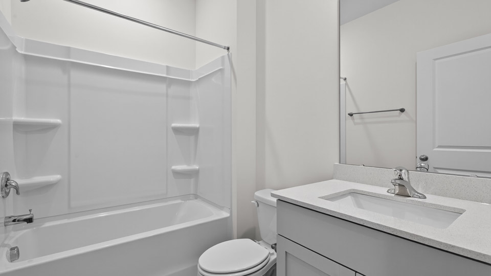 secondary bathroom with shower tub combo and single vanity sink