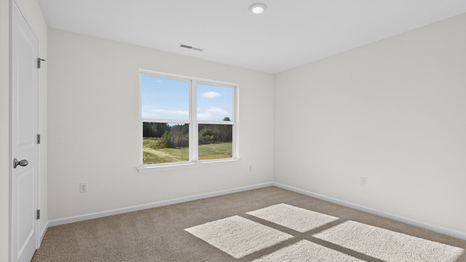 upstairs loft area with large windows and carpeting