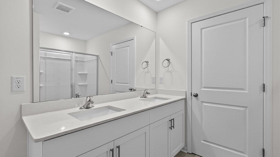 Primary bathroom with double sink and walk-in shower