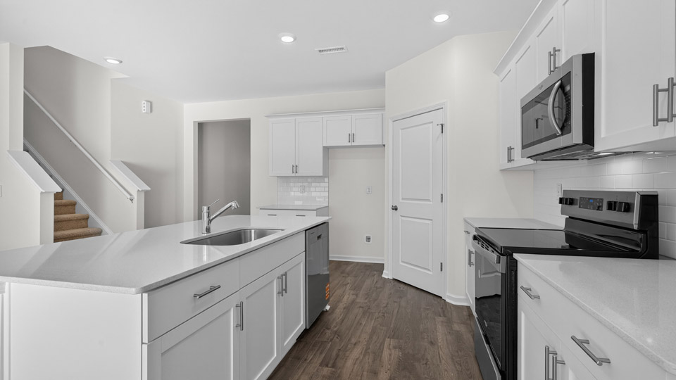 Kitchen with white cabinets and stainless steel appliances.