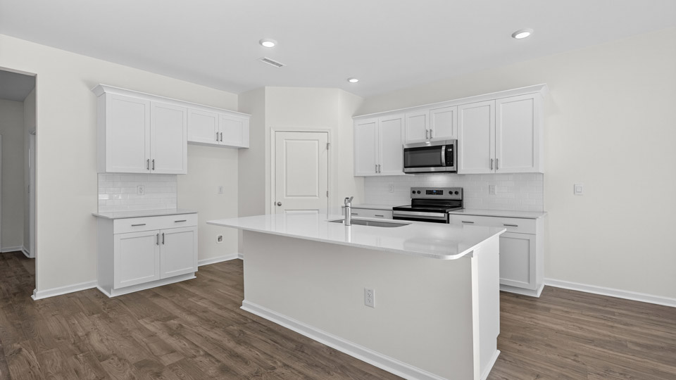 Kitchen with white cabinets and stainless steel appliances.