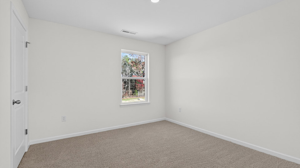 Bedroom with carpet floor and closet and window