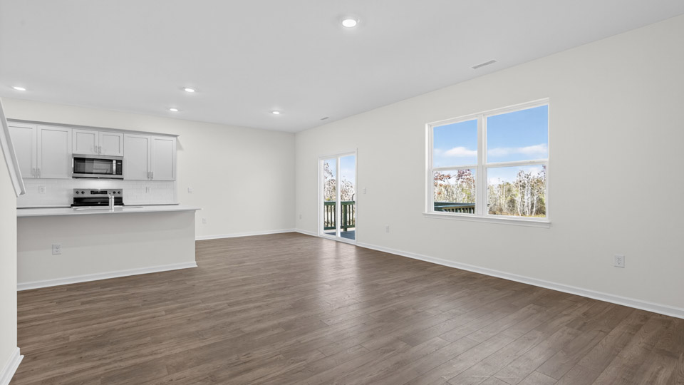 Open-concept living room leading to kitchen