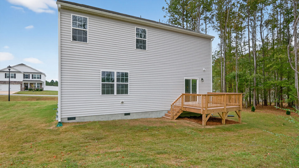 back exterior of wilmington A with deck and large yard