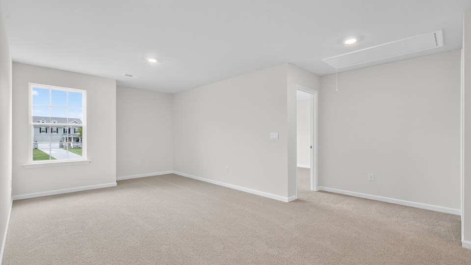 upstairs loft area with large windows and carpeting