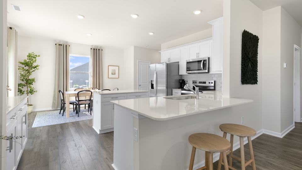 kitchen with quartz counters, kitchen island, pantry, stainless steel appliances