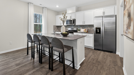 kitchen with island quartz countertops and white cabinets