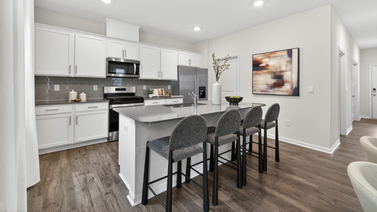 kitchen with island quartz countertops and white cabinets