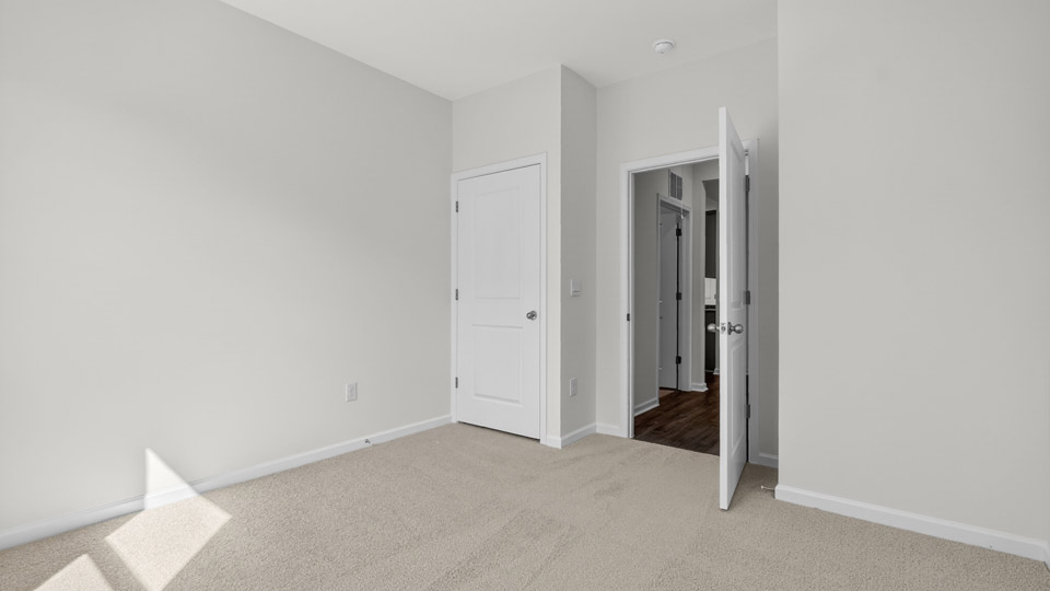 additional bedroom with window, carpeting, closet