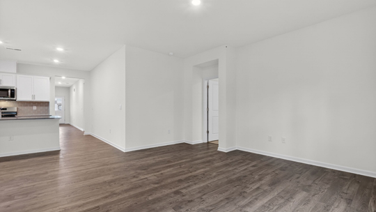 kitchen with quartz counters, kitchen island, pantry, stainless steel appliances