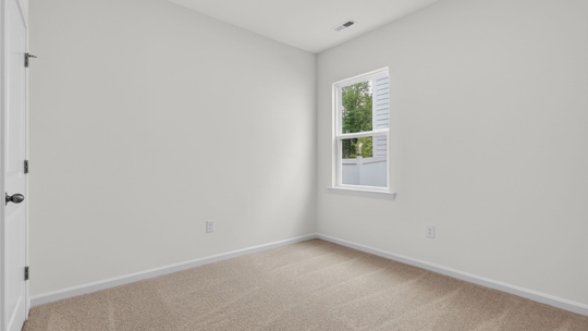 secondary bedroom with window and closet, carpeting