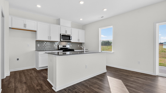 kitchen with gray tile backsplash island and quartz countertops