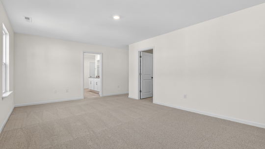 primary bedroom with carpet flooring