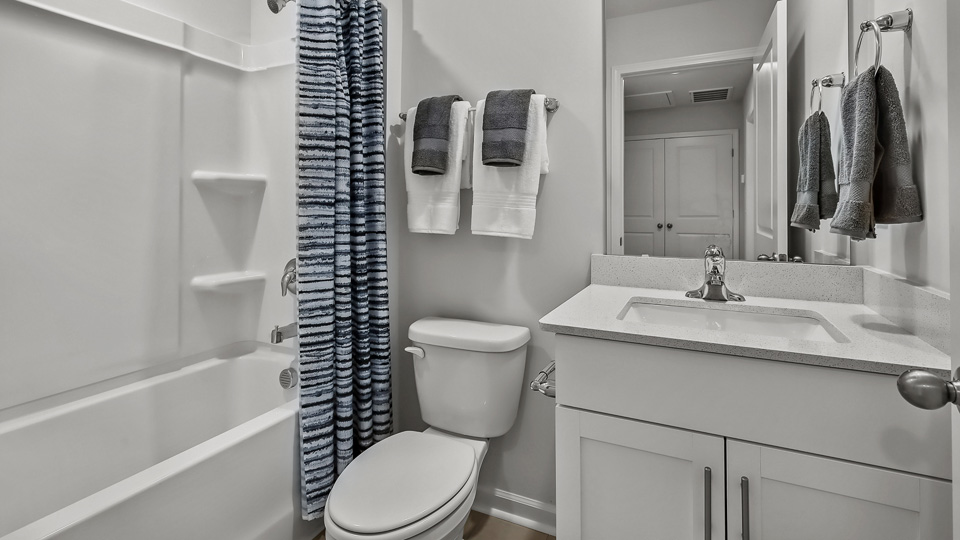 secondary bathroom with shower tub combo and single vanity sink