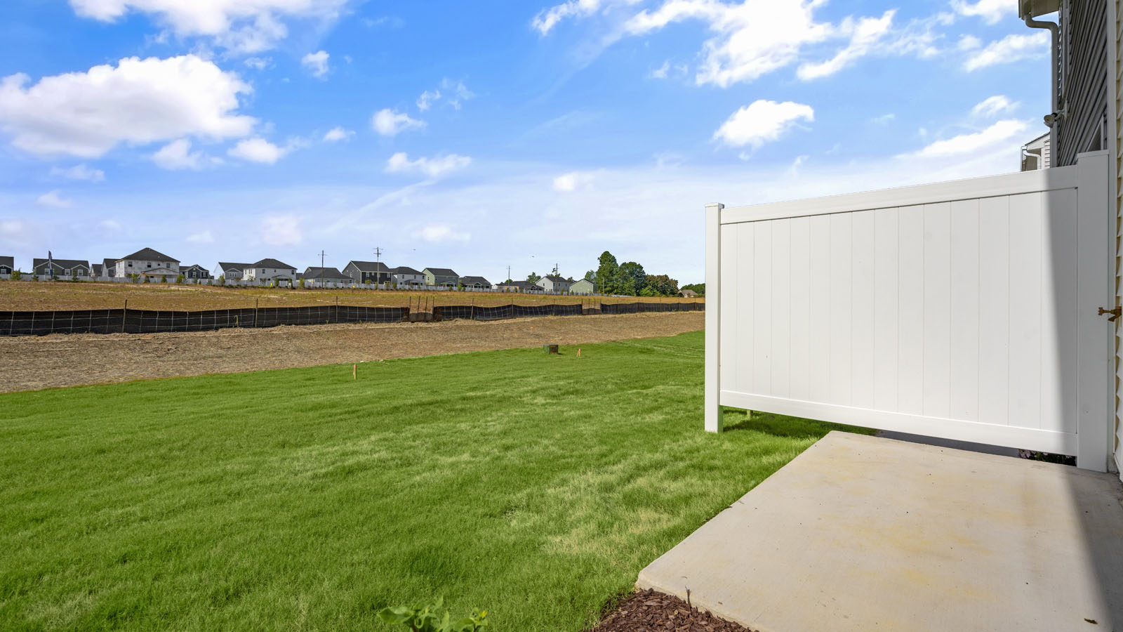 exterior patio with concrete slab and open yard
