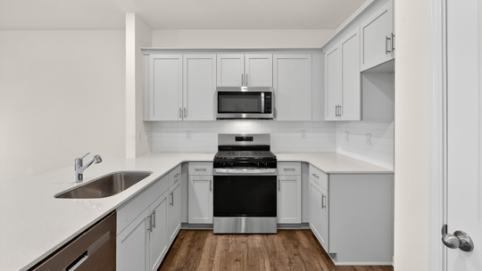 kitchen with white cabinets and quartz countertops