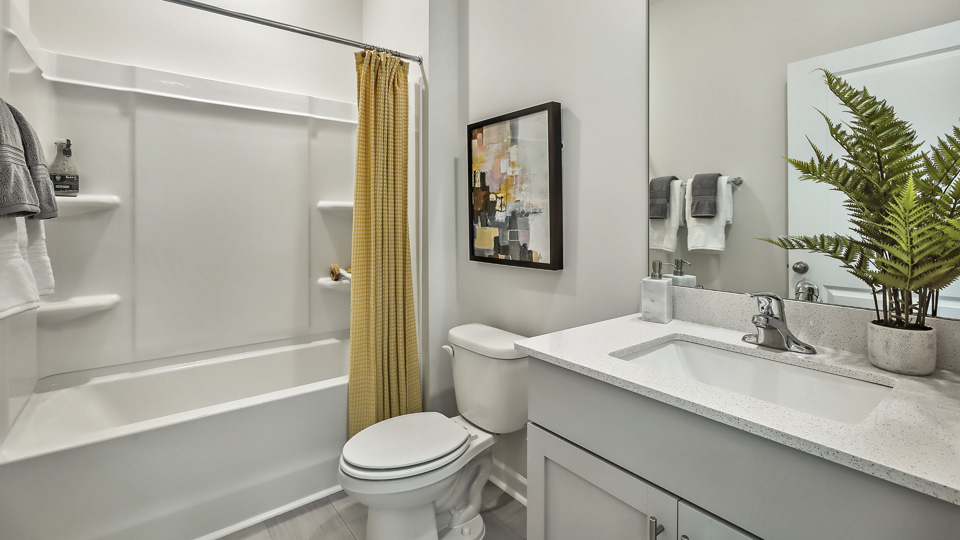 secondary bathroom with shower tub combo and single vanity sink