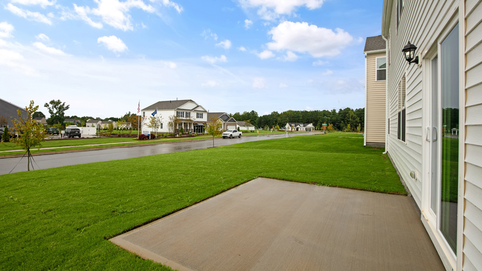 exterior patio with concrete slab and open yard