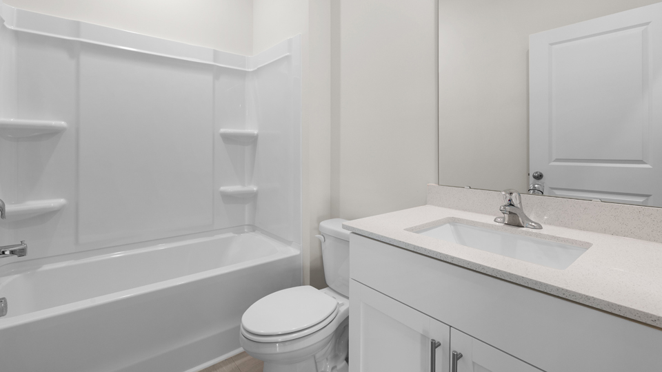 secondary bathroom with shower tub combo and single vanity sink