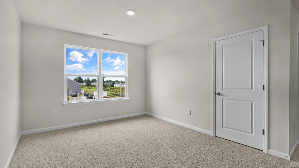 upstairs loft area with large windows and carpeting