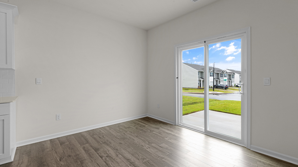open concept dining space with door to patio
