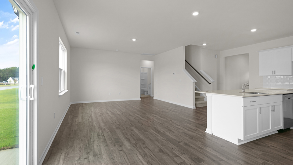 kitchen with quartz counters, kitchen island, pantry, stainless steel appliances