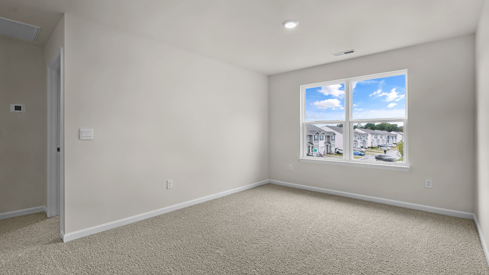 upstairs loft area with large windows and carpeting