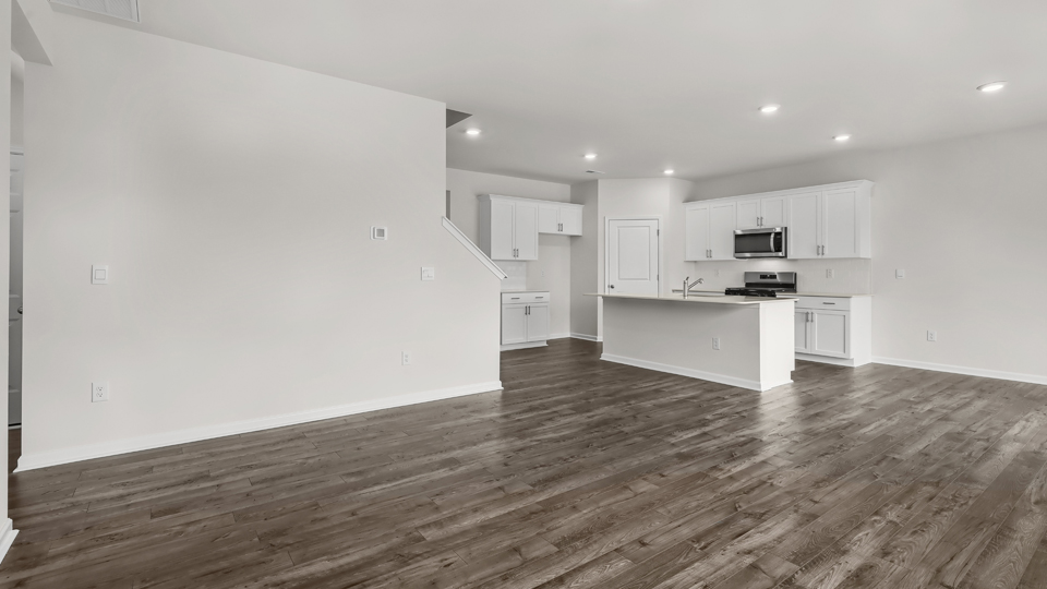 kitchen with quartz counters, kitchen island, pantry, stainless steel appliances