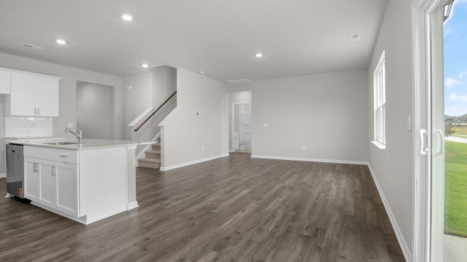 kitchen with quartz counters, kitchen island, pantry, stainless steel appliances