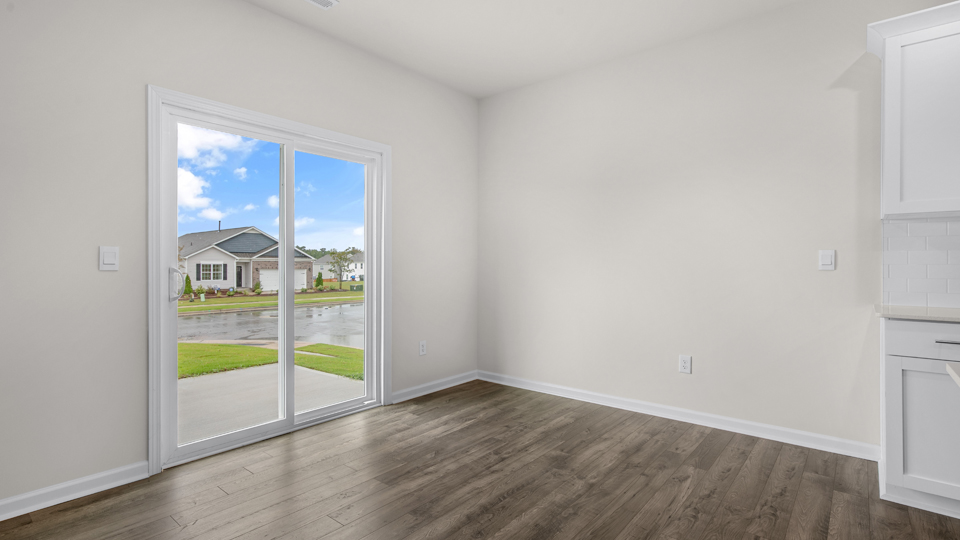 open concept dining space with door to patio