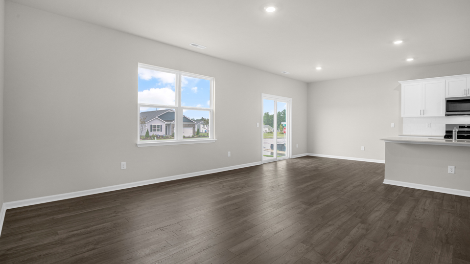 kitchen with quartz counters, kitchen island, pantry, stainless steel appliances
