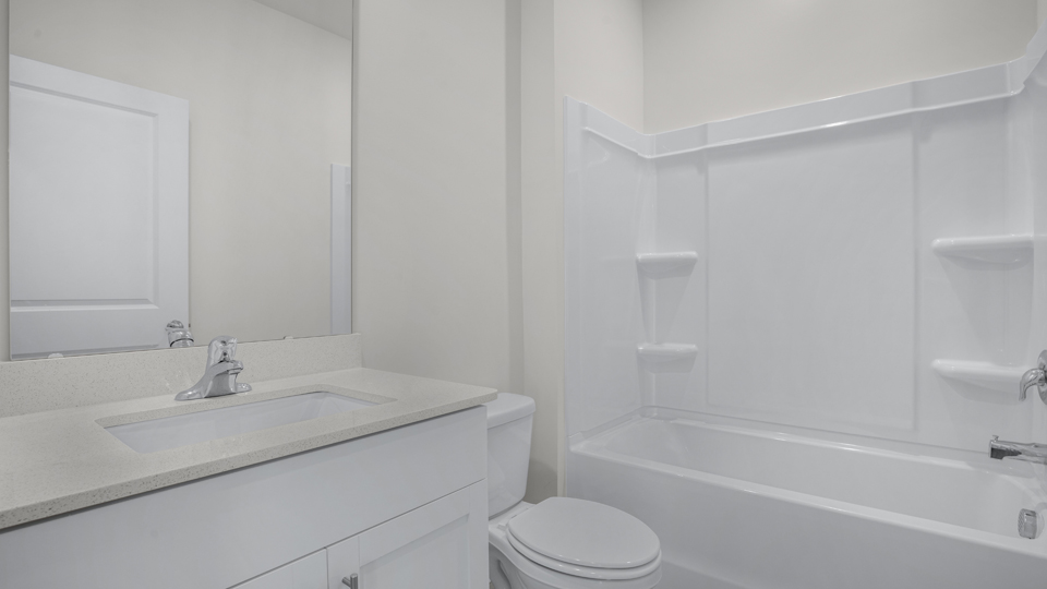 secondary bathroom with shower tub combo and single vanity sink